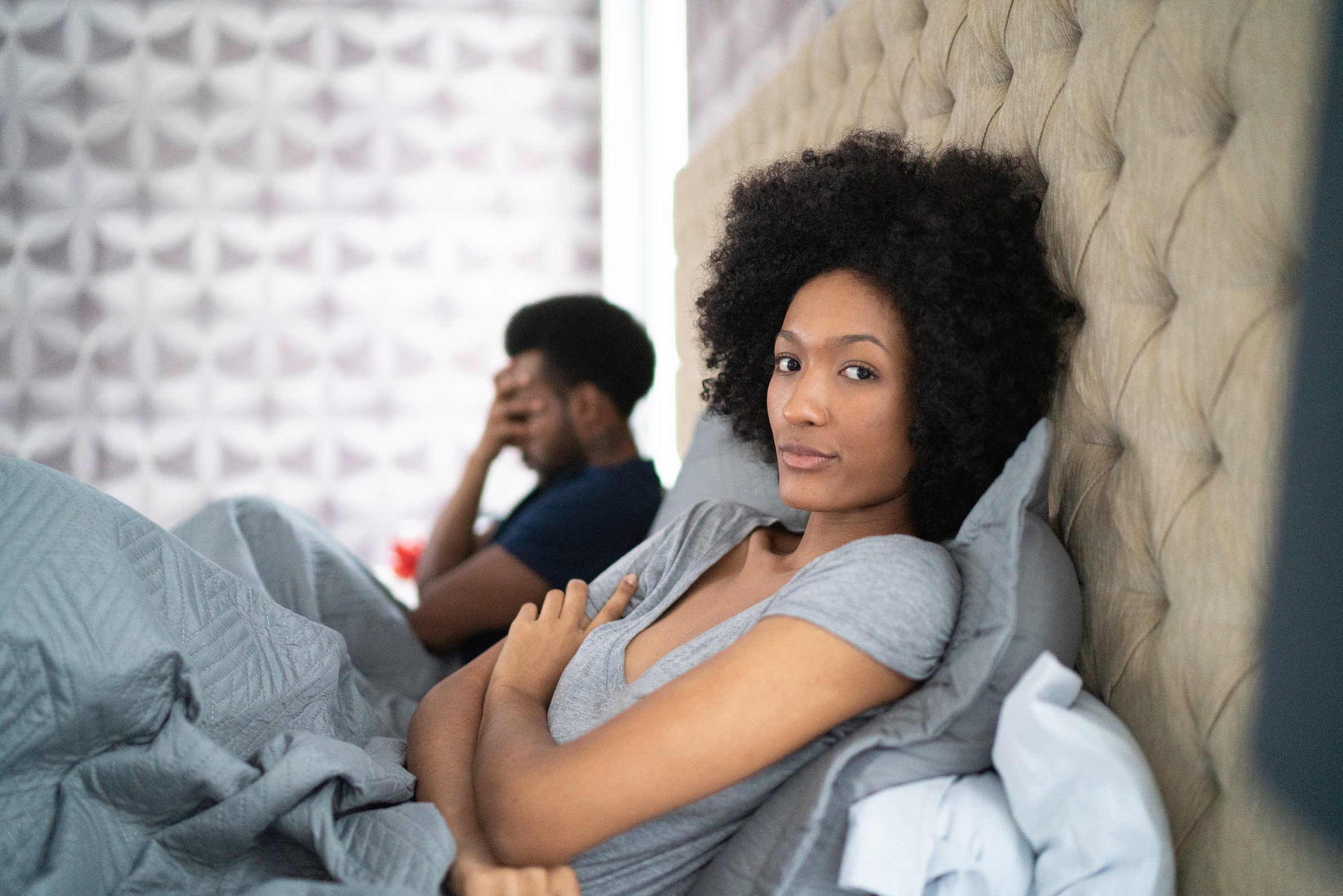 Couple arguing in bed