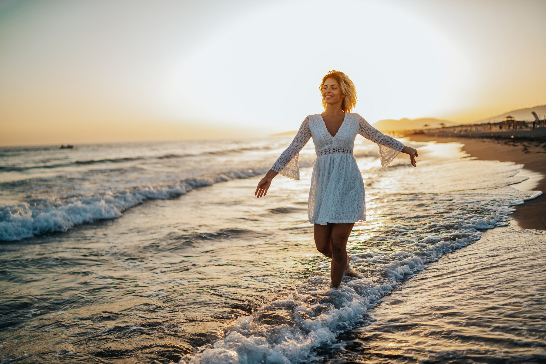 Happy woman dancing on beach