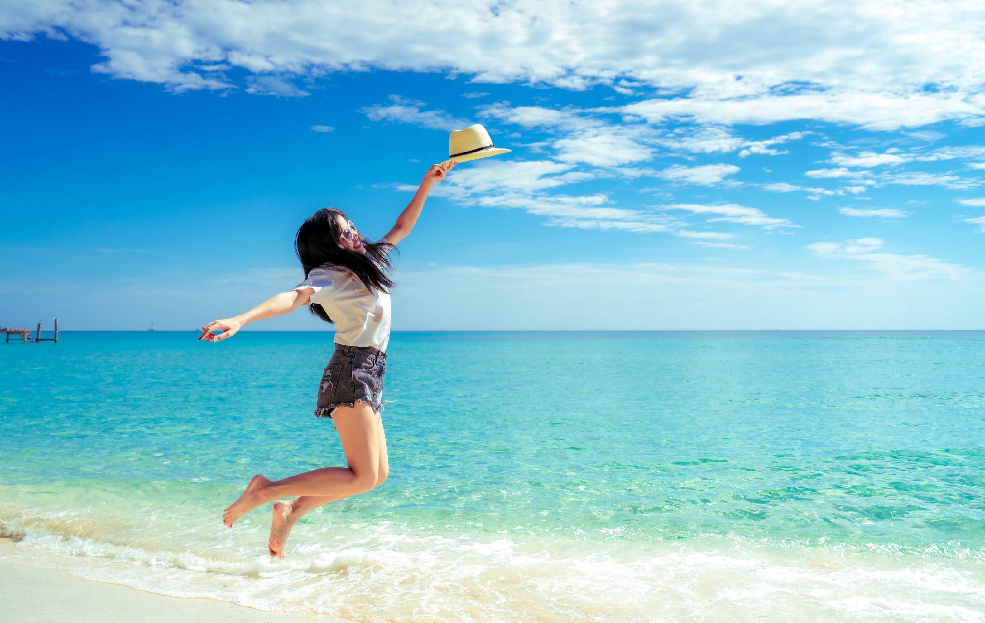 Happy Woman Jumping at the Beach