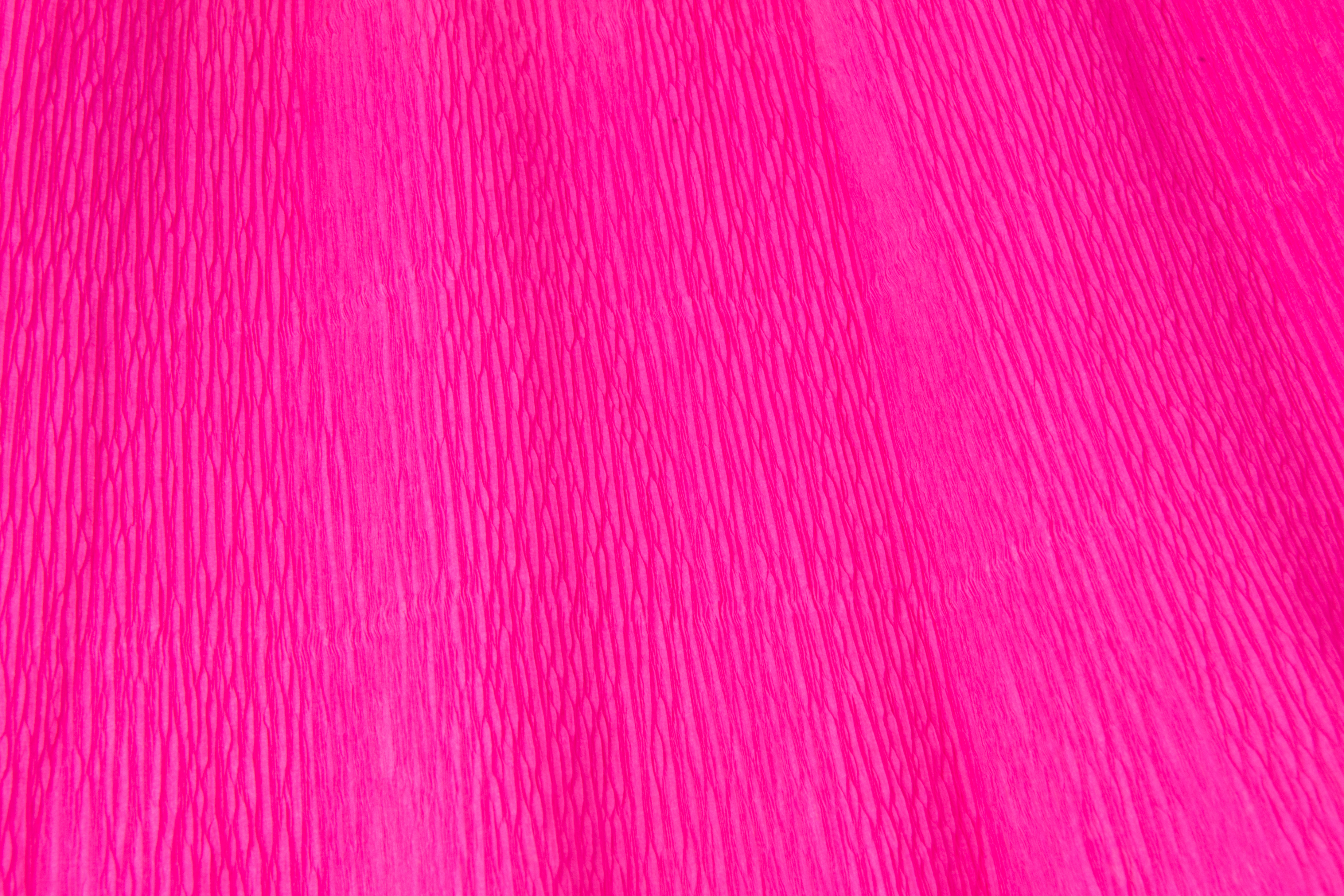 Neon pink crepe paper wallpaper