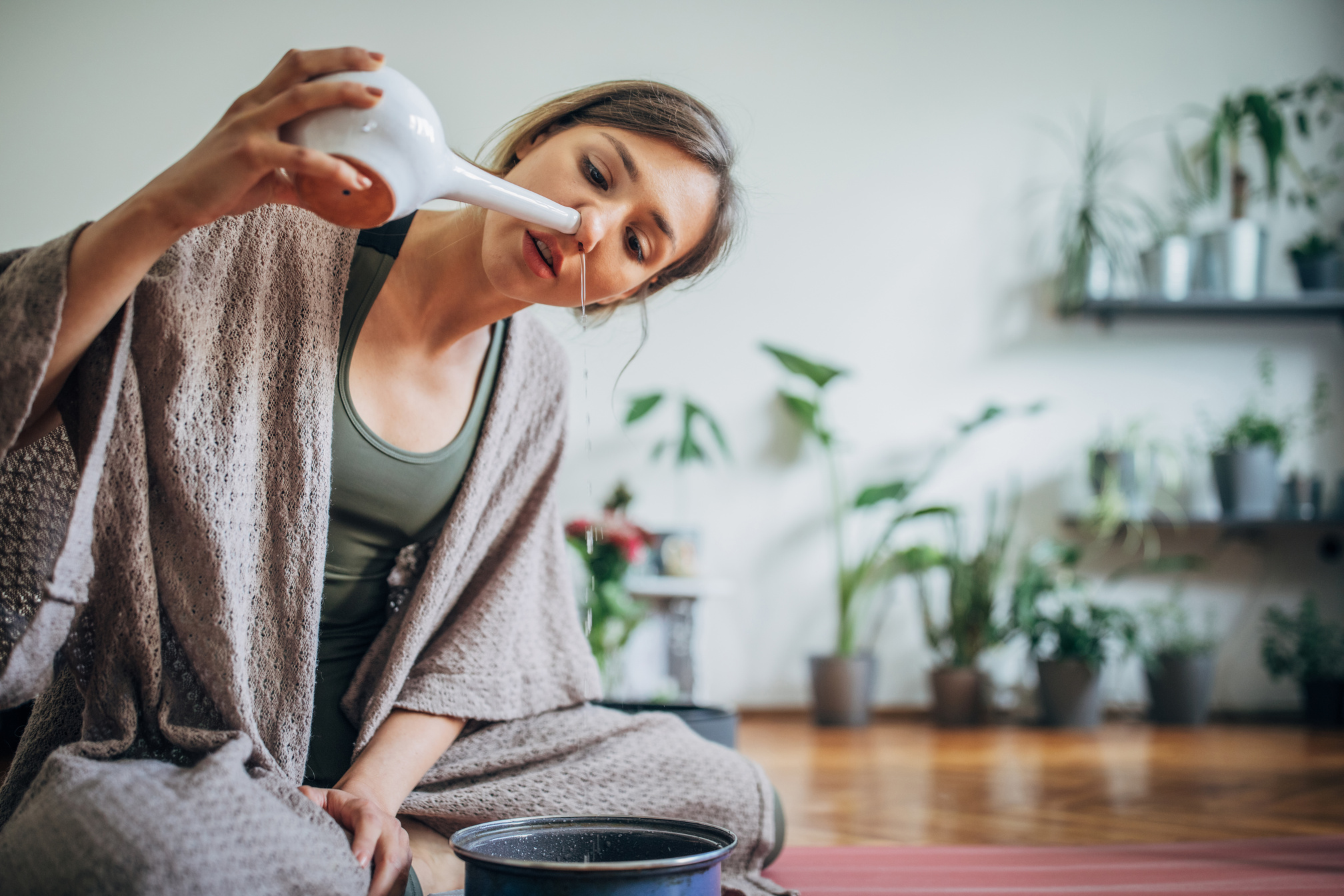 Young woman using neti pot